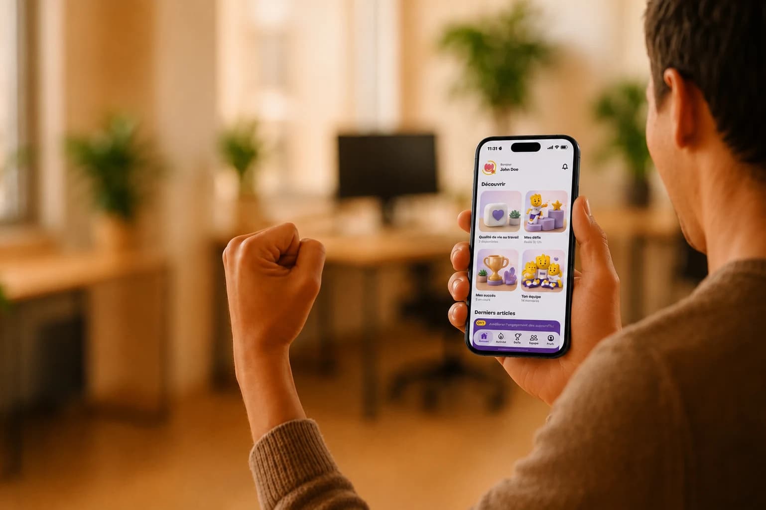 An employee looking at the Mü être mobile app home screen on their phone.